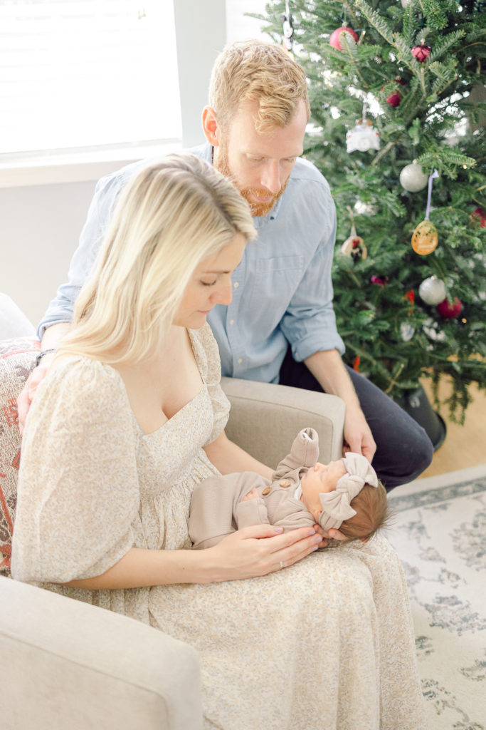 Mom and Dad in The Living Room, Taking Lifestyle Newborn Photos, Taken by Lifestyle Photographer in Charleston, SC