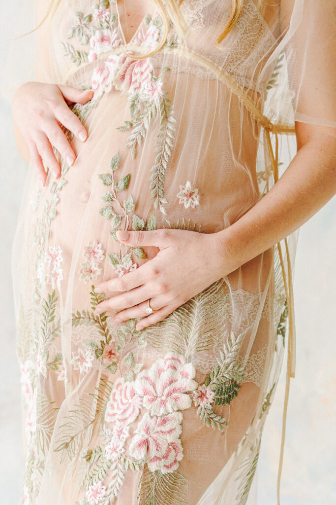 close up image of a pregnant mother holding her belly